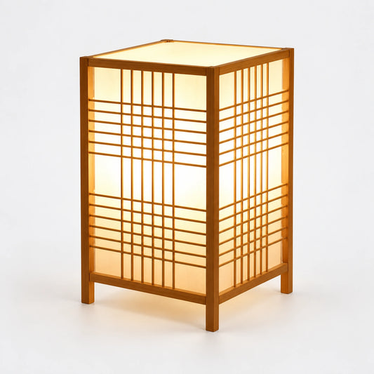 Luminária de mesa Shoji em bambu acesa, com trama geométrica e fundo cinza claro.